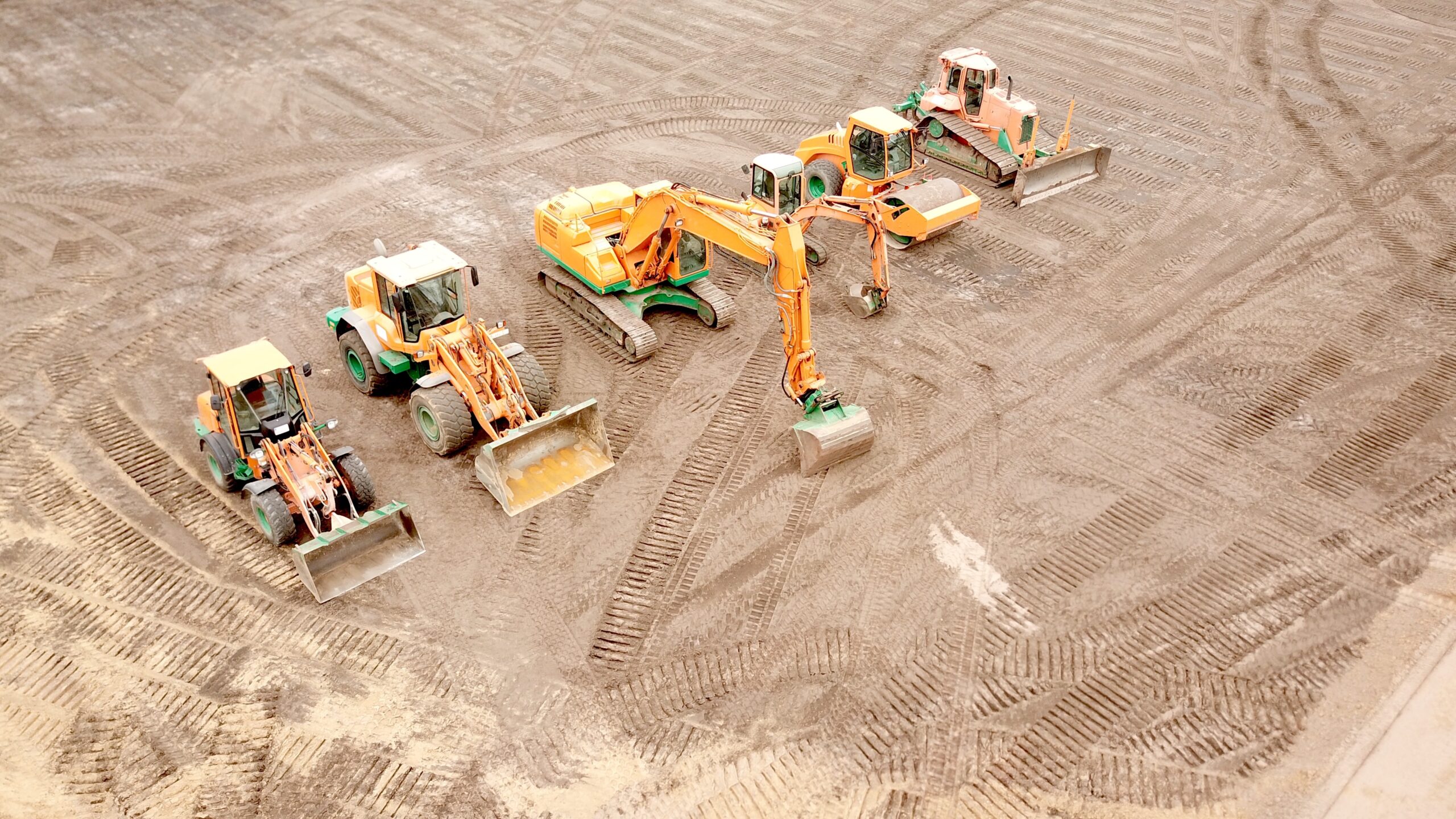 Construction machinery, excavator, wheel loader, roller, bulldozer on a construction site from a bird's eye view